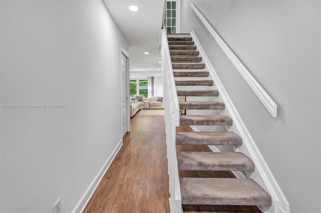 staircase featuring hardwood / wood-style floors