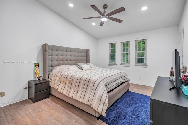 bedroom featuring ceiling fan, lofted ceiling, and hardwood / wood-style floors