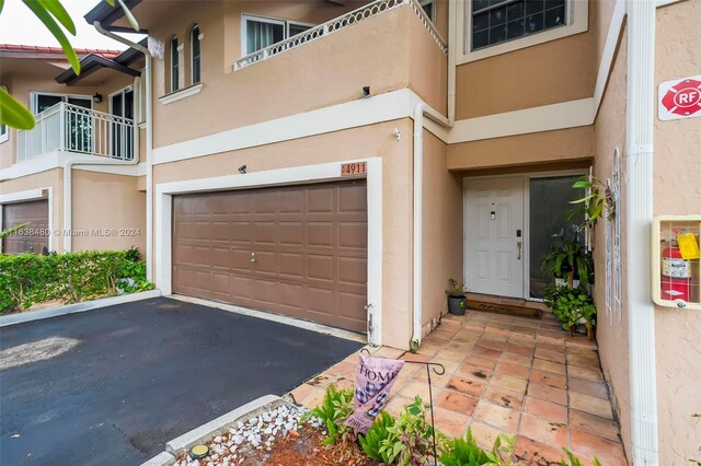 exterior space featuring a garage and a balcony