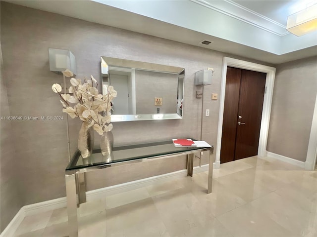 interior space featuring tile patterned flooring and ornamental molding