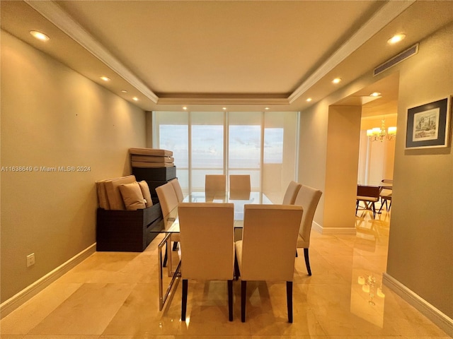 dining area featuring a notable chandelier and a tray ceiling