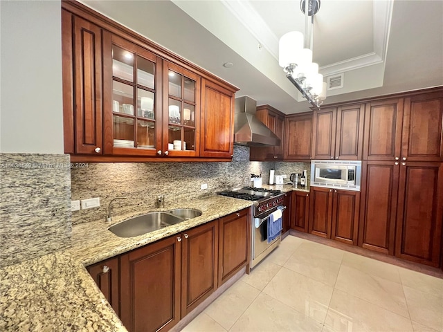 kitchen featuring ornamental molding, decorative light fixtures, sink, wall chimney exhaust hood, and appliances with stainless steel finishes