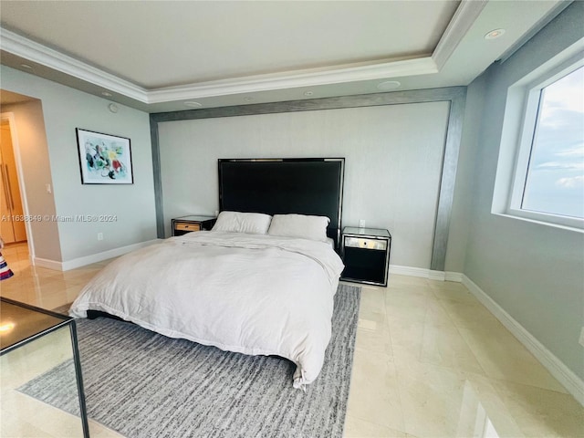 bedroom with a raised ceiling, baseboards, and ornamental molding