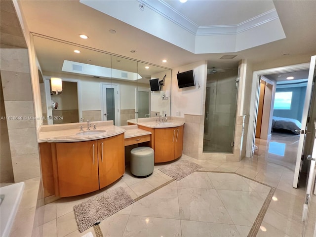 full bathroom with a sink, recessed lighting, tile walls, a shower stall, and crown molding