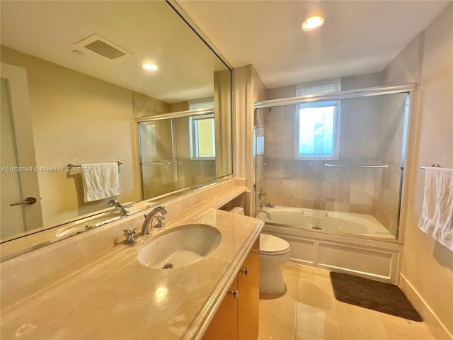 bathroom with visible vents, toilet, tile patterned floors, combined bath / shower with glass door, and vanity