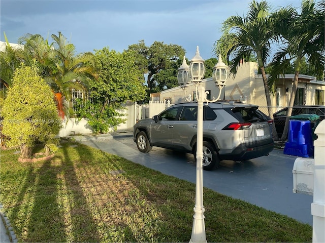 view of vehicle parking with a yard