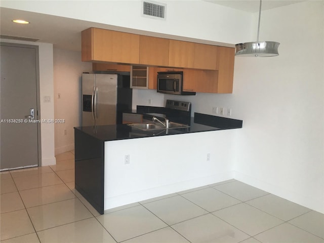 kitchen featuring appliances with stainless steel finishes, light tile patterned flooring, and sink