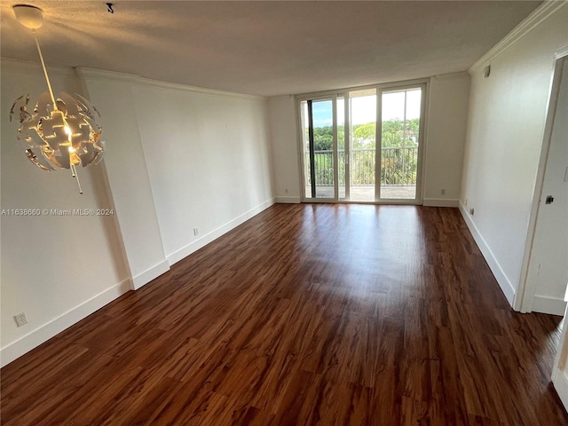 spare room with dark wood-type flooring and ornamental molding