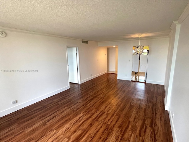 unfurnished room with a textured ceiling, dark wood-type flooring, and a chandelier