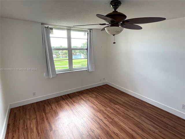 spare room with ceiling fan, a textured ceiling, and wood-type flooring