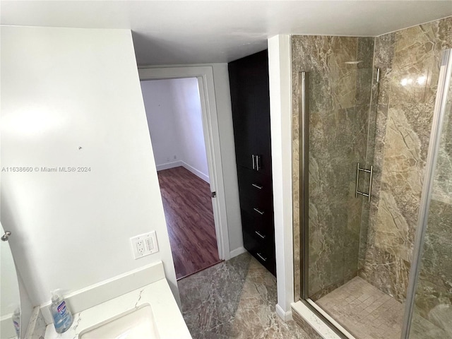 full bathroom featuring a stall shower, baseboards, and marble finish floor