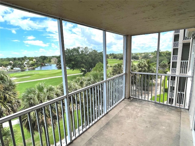 unfurnished sunroom with a water view and golf course view