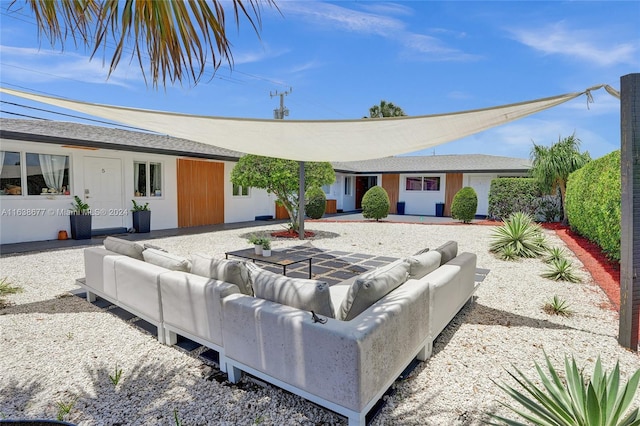 rear view of property featuring an outdoor living space