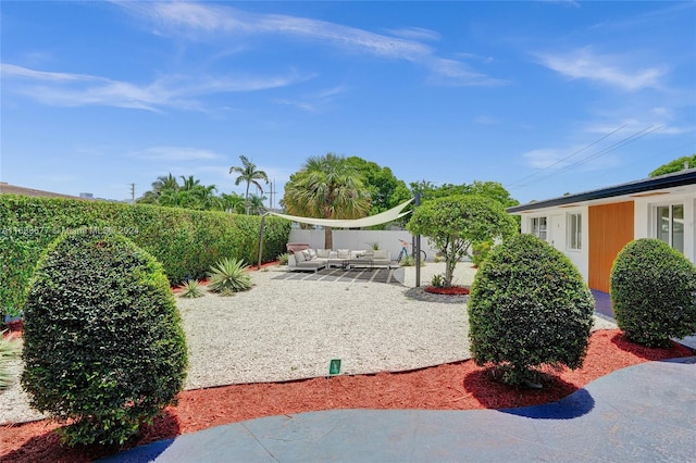 view of yard with an outdoor living space, a patio area, and fence