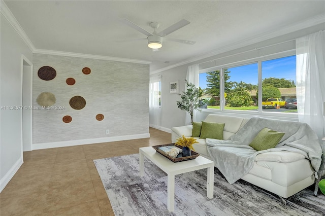 living room with baseboards, light tile patterned flooring, ceiling fan, ornamental molding, and an accent wall