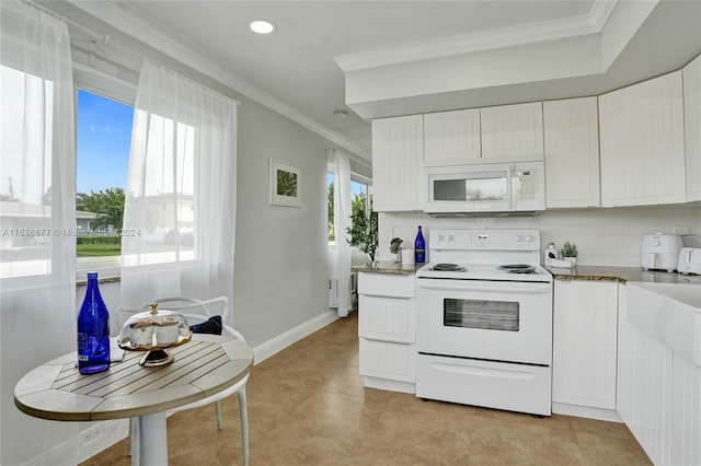 kitchen with backsplash, white appliances, white cabinetry, and crown molding