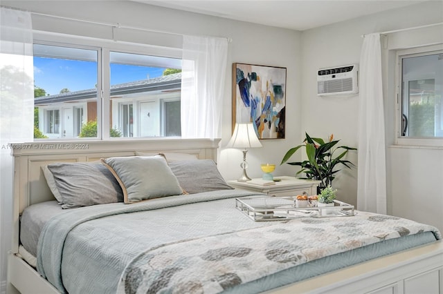 bedroom with an AC wall unit