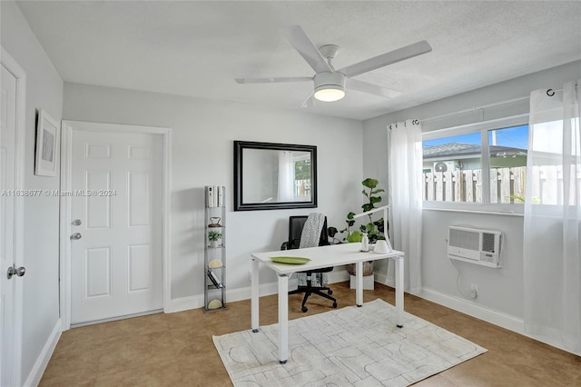 office space with a ceiling fan, baseboards, a wall mounted air conditioner, and a textured ceiling