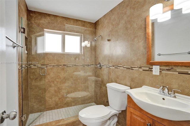 bathroom with toilet, a stall shower, tile walls, decorative backsplash, and vanity