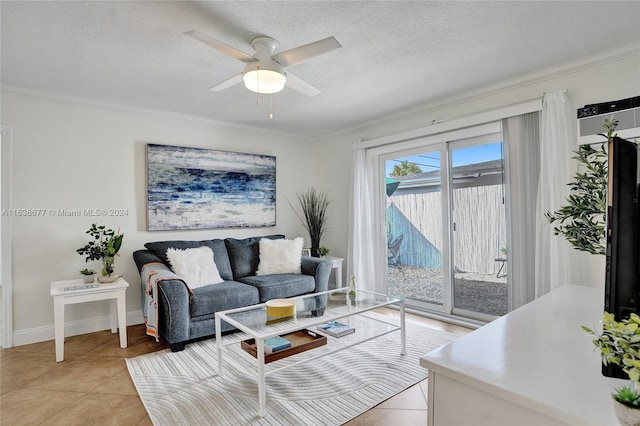 living room with ceiling fan, crown molding, light tile patterned floors, and a textured ceiling