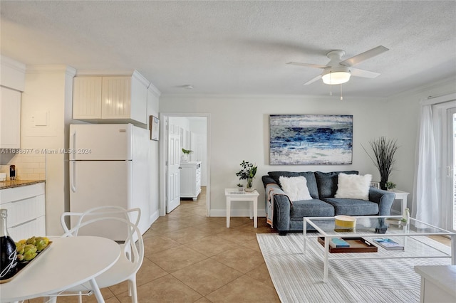 living area featuring light tile patterned floors, a textured ceiling, crown molding, and a ceiling fan