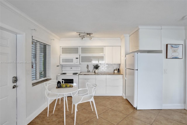 kitchen featuring tasteful backsplash, white appliances, white cabinets, light tile patterned floors, and glass insert cabinets