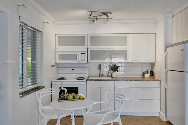 kitchen featuring backsplash, crown molding, white cabinets, white appliances, and a sink