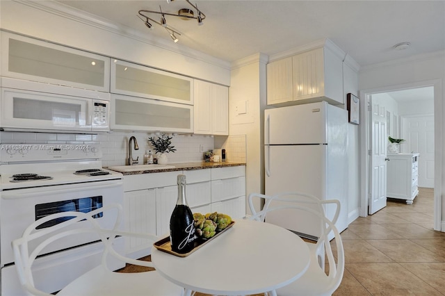 kitchen with white appliances, backsplash, crown molding, sink, and light tile patterned flooring