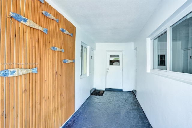 hall with a textured ceiling