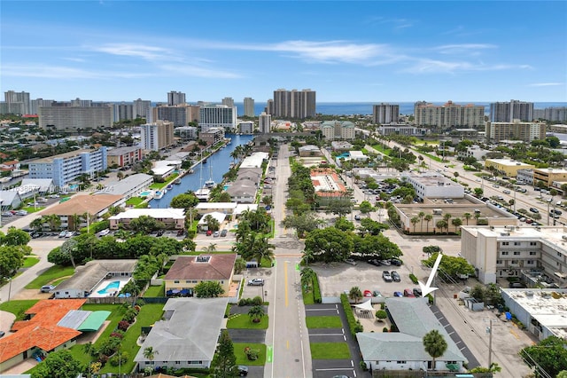 drone / aerial view featuring a view of city and a water view