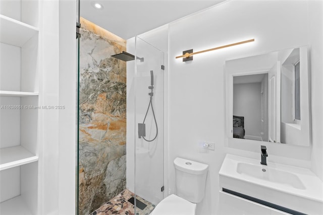 bathroom with toilet, an enclosed shower, and vanity