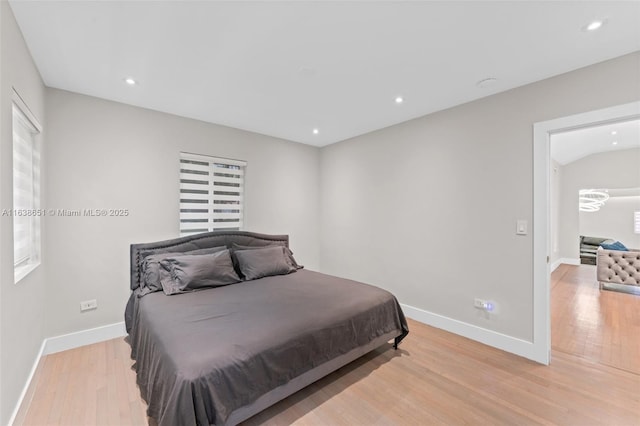 bedroom with recessed lighting, light wood-type flooring, and baseboards