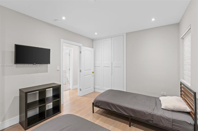 bedroom with a closet and light wood-type flooring