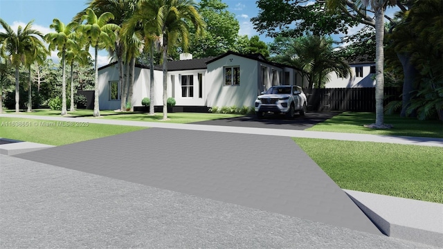manufactured / mobile home featuring a front lawn and fence