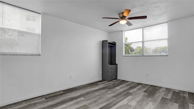 spare room with ceiling fan and wood-type flooring