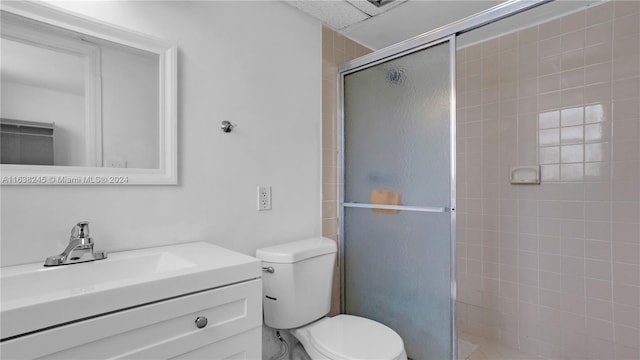 bathroom featuring walk in shower, vanity, and toilet