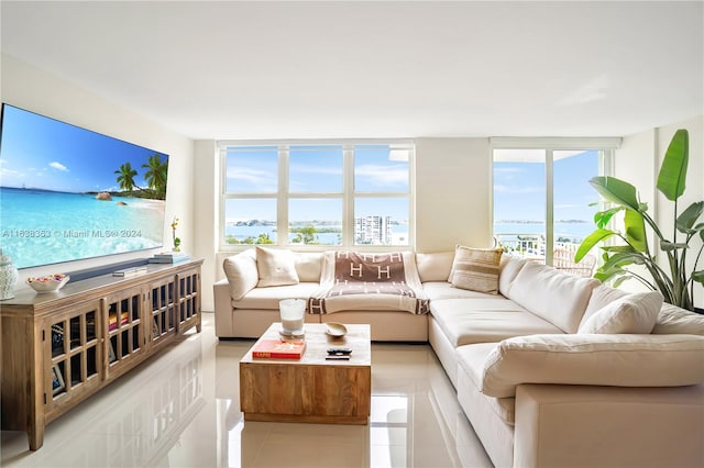 tiled living room featuring expansive windows