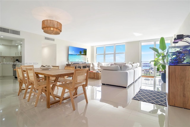 tiled dining space featuring expansive windows