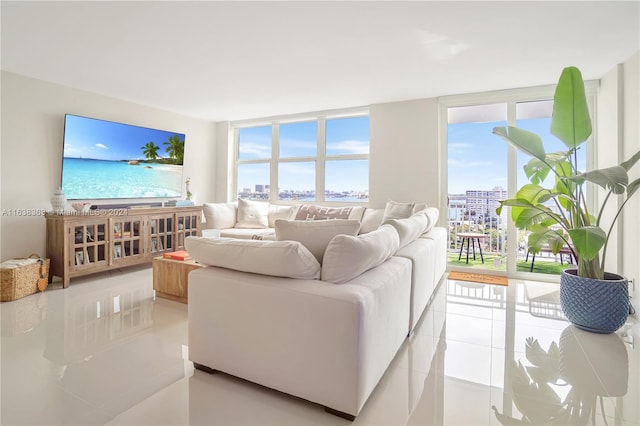 living room featuring light tile patterned flooring and expansive windows