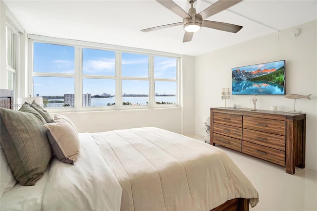 bedroom with ceiling fan and light tile patterned floors