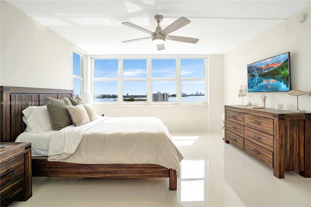 tiled bedroom featuring ceiling fan