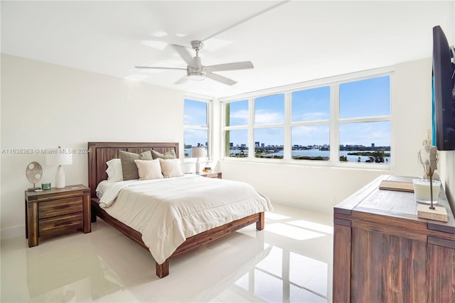 tiled bedroom with ceiling fan and multiple windows