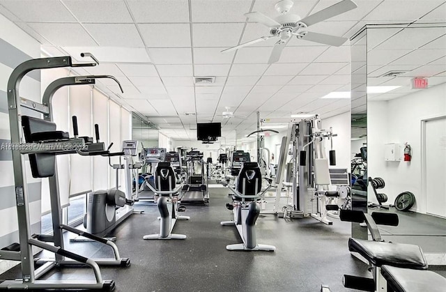 workout area featuring a paneled ceiling and ceiling fan