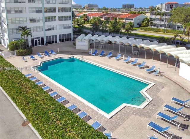 view of pool featuring central air condition unit and a patio area