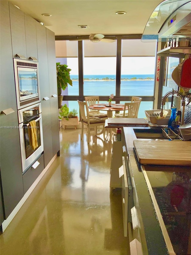 dining area featuring plenty of natural light and a water view