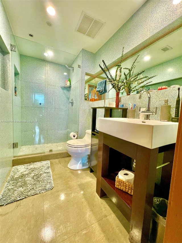 bathroom featuring vanity, toilet, and an enclosed shower