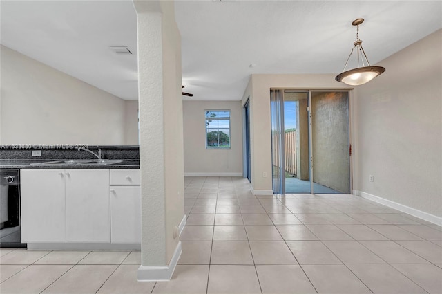 kitchen featuring hanging light fixtures, white cabinets, ceiling fan, light tile patterned flooring, and sink