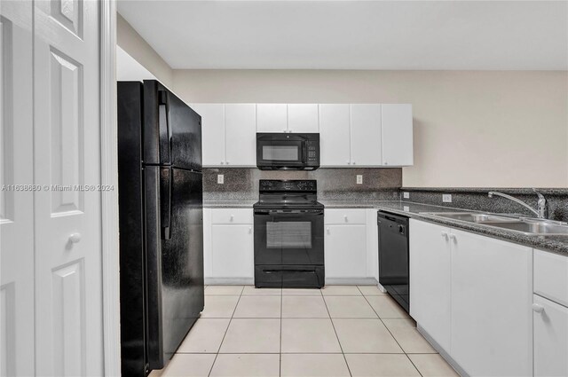 kitchen featuring white cabinets, black appliances, light tile patterned floors, tasteful backsplash, and sink