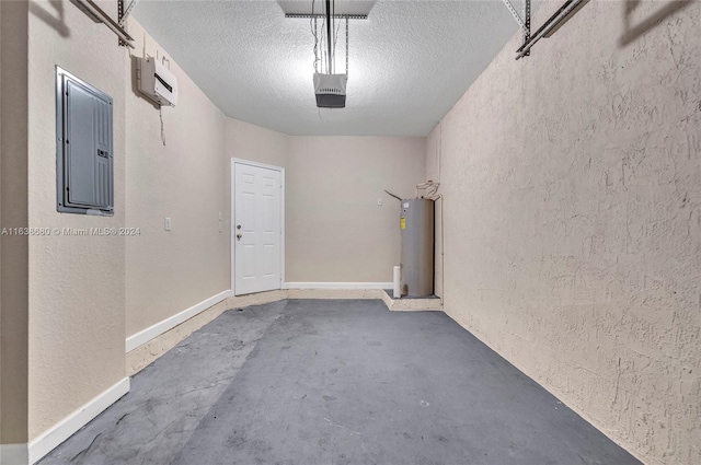 garage featuring water heater, electric panel, and a garage door opener