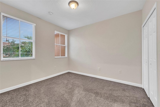 unfurnished bedroom with carpet flooring and a closet